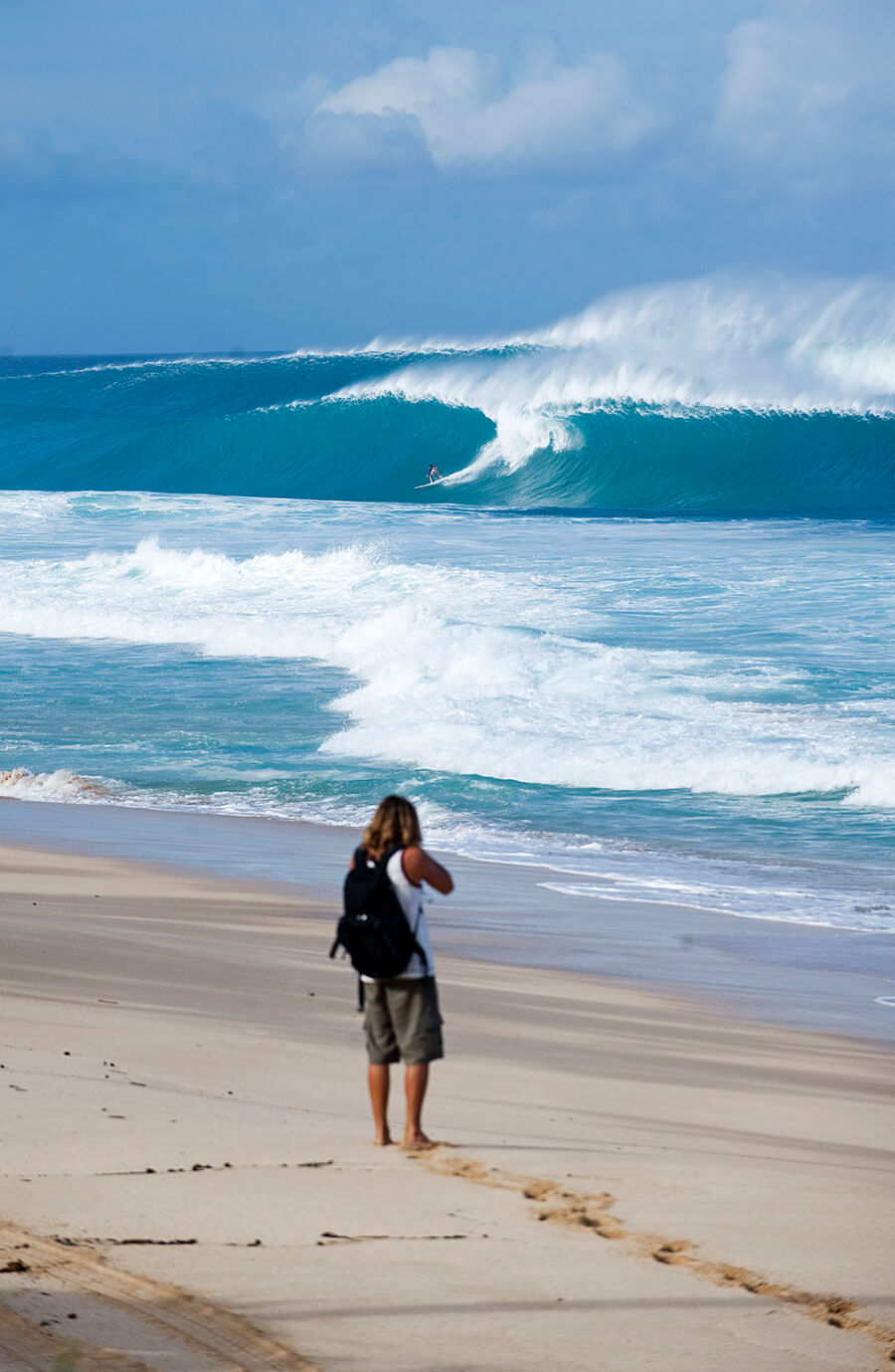 Photographer on the beach shooting Backdoor (wave) in Hawaii