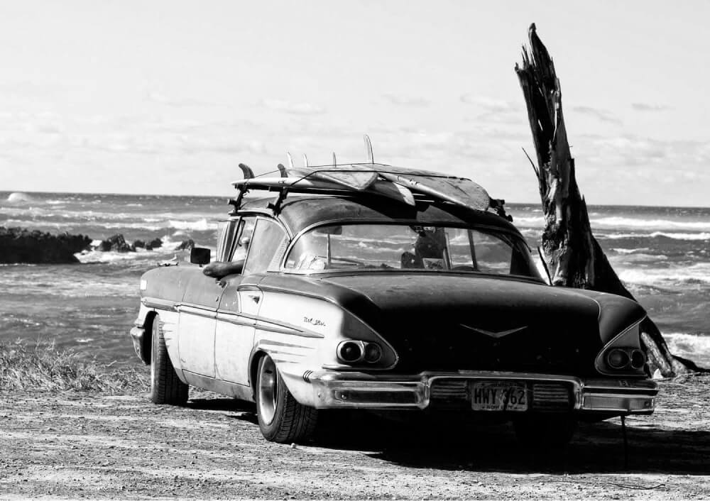 Vintage car in front of a surf break