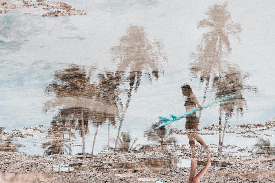 Lidia Mariamm (female surfer reflection in water)