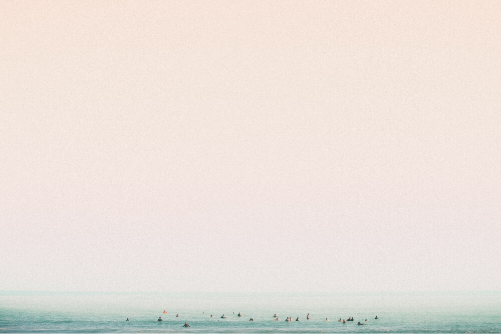 A crowd of surfer sitting and waiting in the ocean