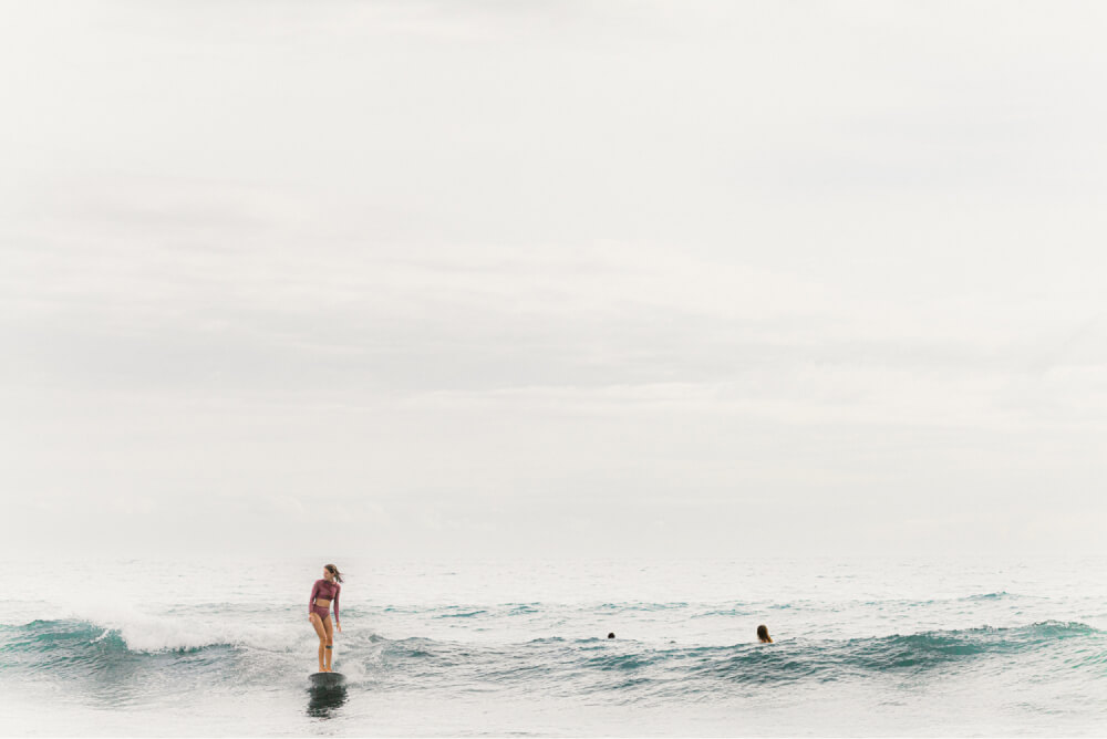 Female surfer riding a small wave