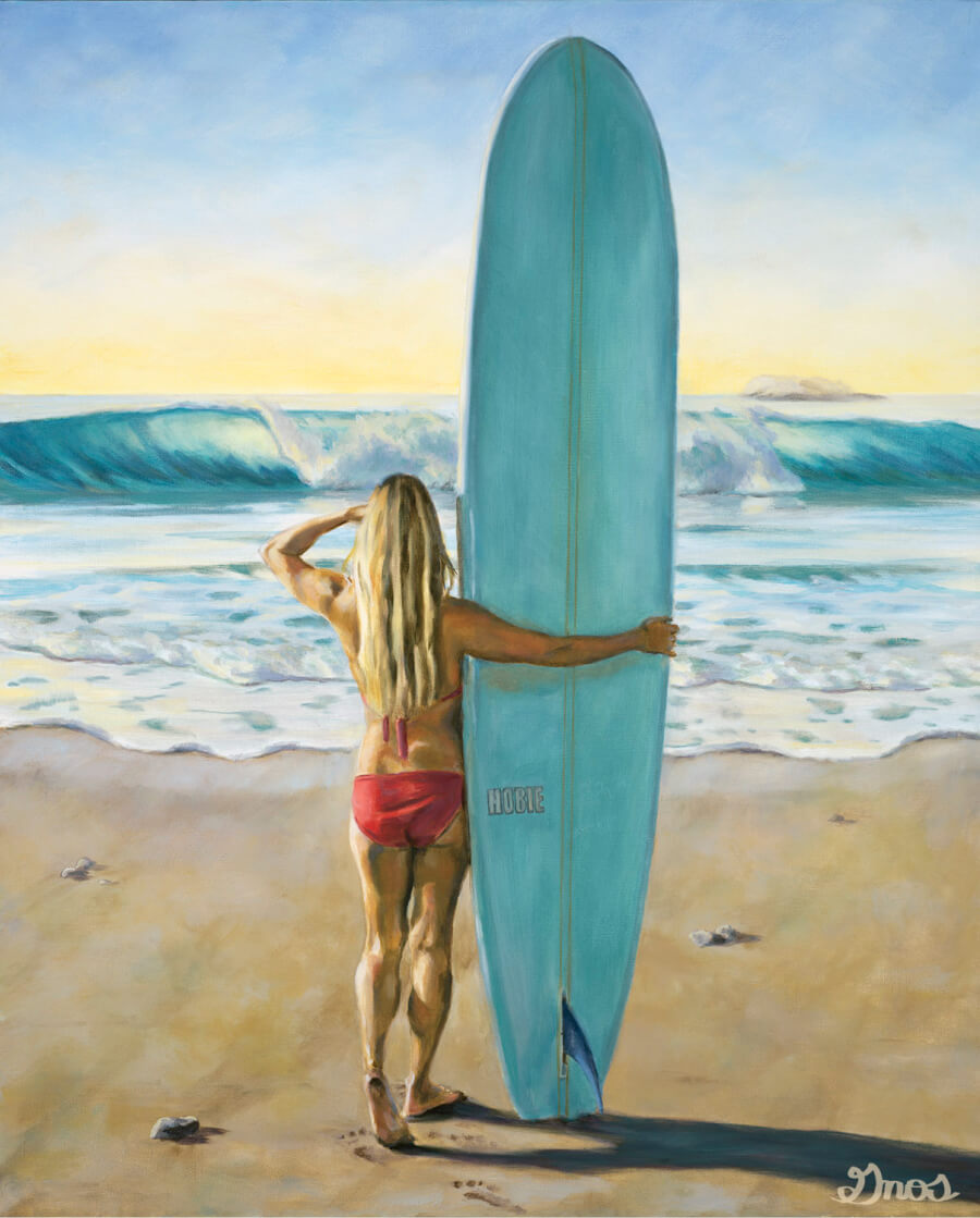Female surfer in red bikini holding surfboard on the beach