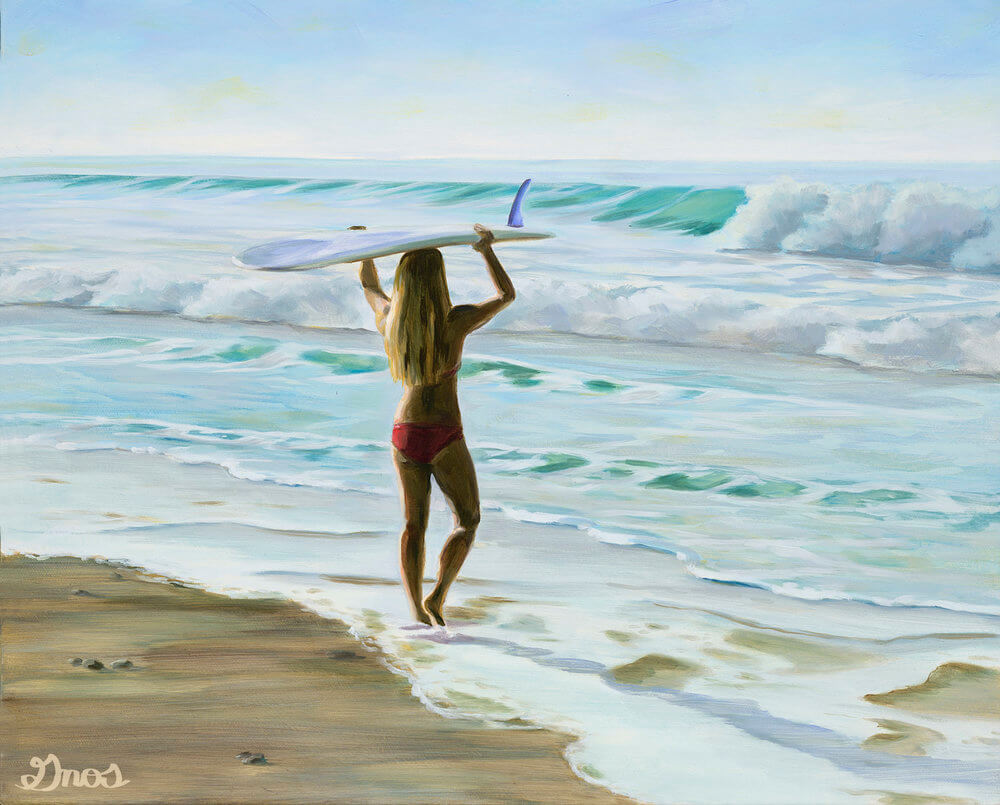 Female surfer holding surfboard above head