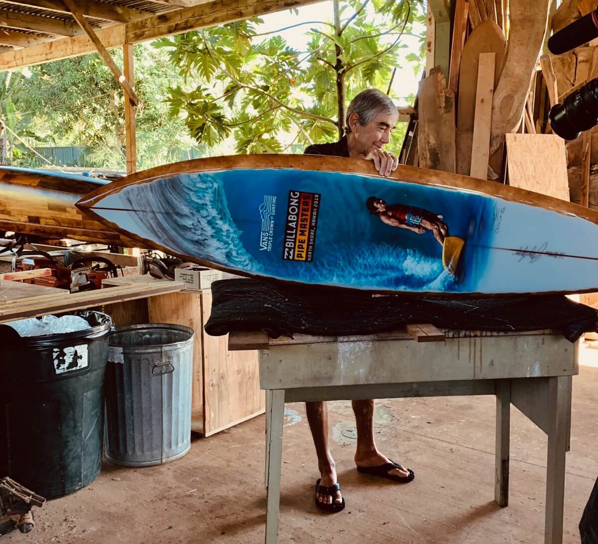 Gerry Lopez with the 2018 Pipe Masters trophy surfboard featuring art by Phil Roberts