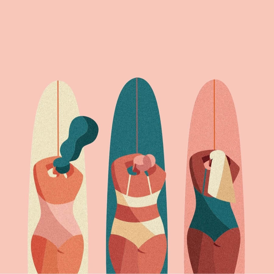 Surfer girls lying on surfboards
