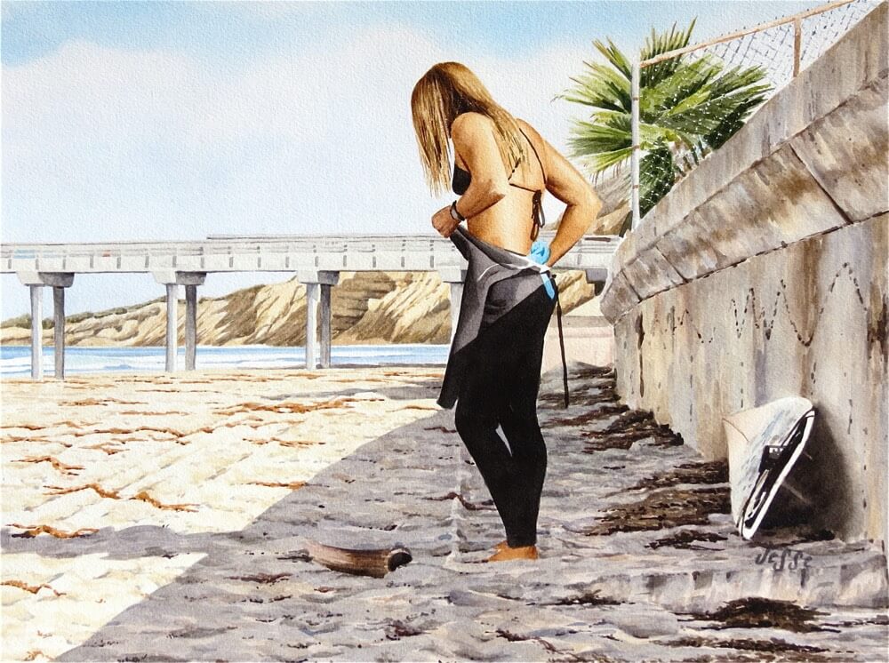 Surfer girl putting on her wetsuit