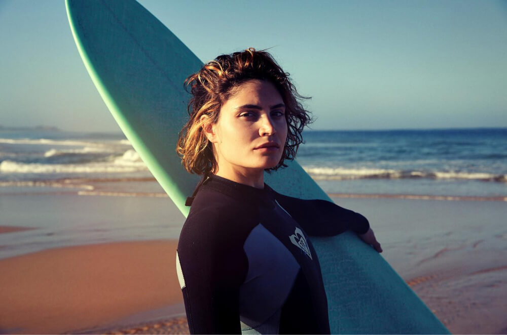 Portrait of female surfer in wetsuit