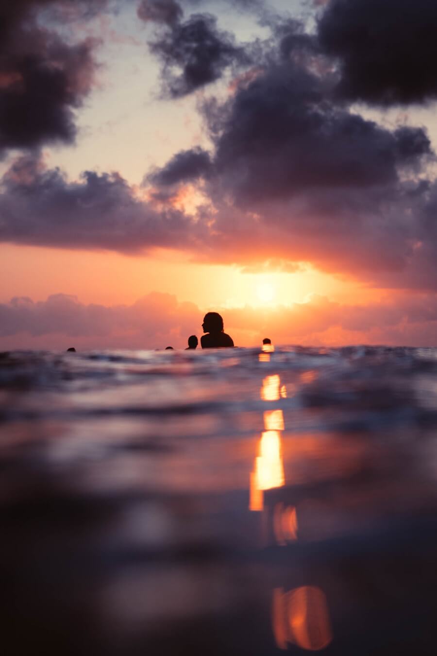 Sunset silhouette surfers