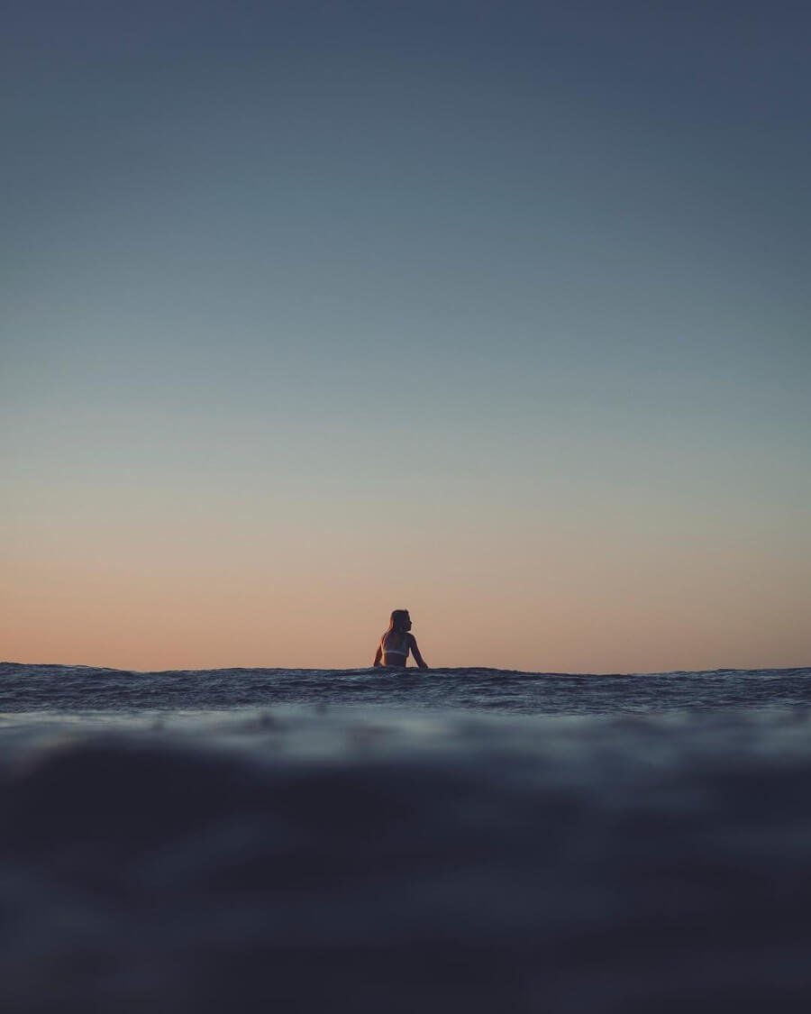 Lone sunset surfer