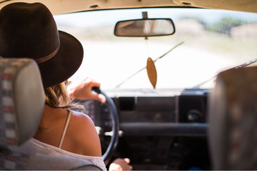 Surfer girl in car