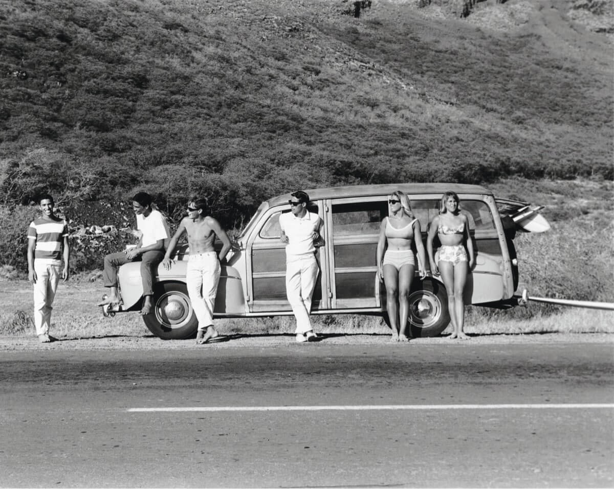 Surfers and a woodie (car)