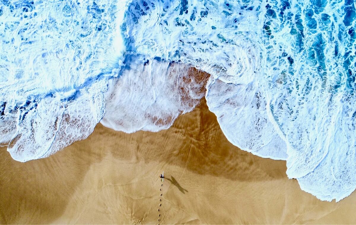 Aerial shot of surfer at Log Cabins, Oahu, Hawaii. Photo by Morgan Maassen