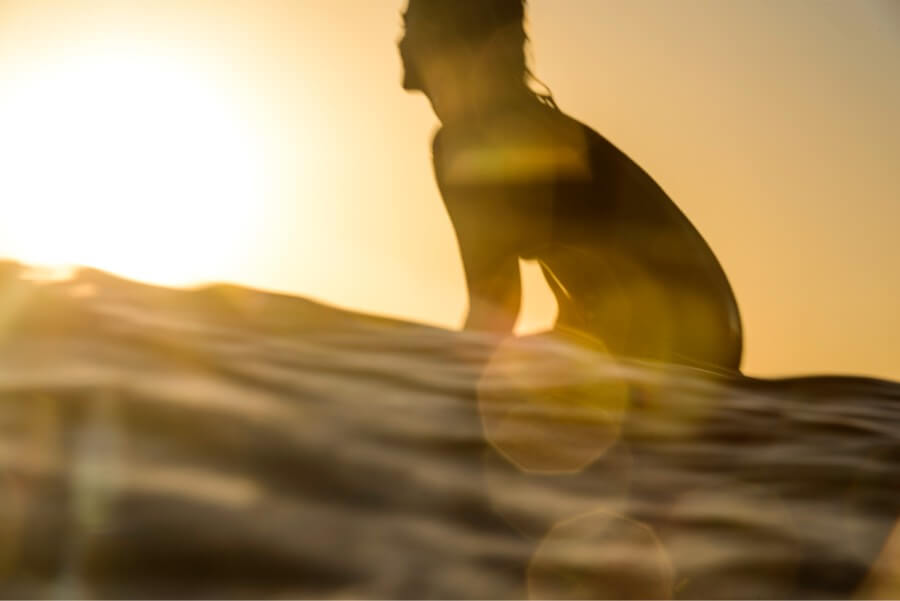 Silhouette sunset surfer