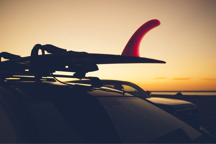 Surfboard mounted on cat sunset