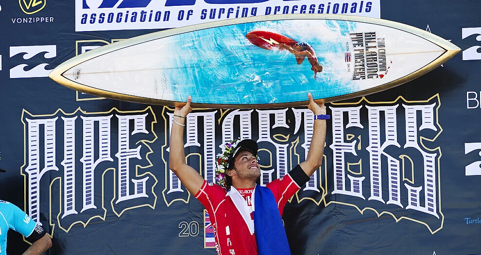 2010 Pipe Masters champion, Jeremy Flores with the trophy surfboard by Gerry Lopez and Phil Roberts