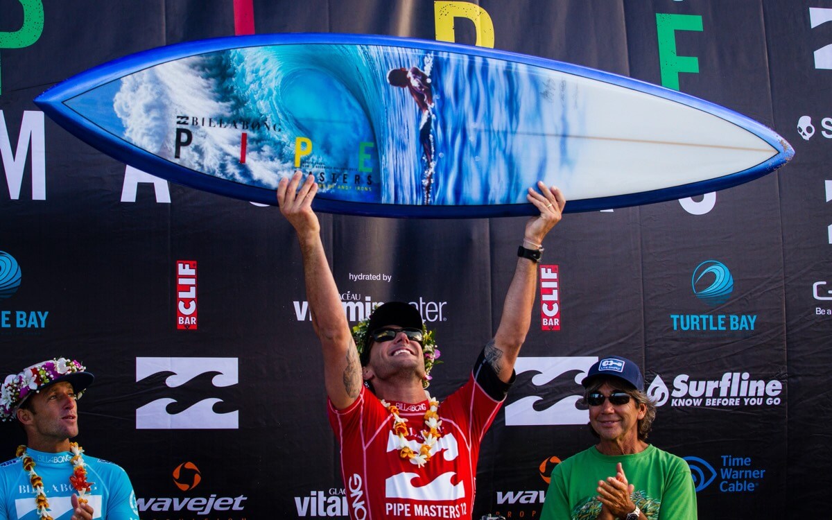 2012 Pipe Masters winner, Joel Parkinson with the Pipe Masters trophy surfboard by Phil Roberts and Gerry Lopez