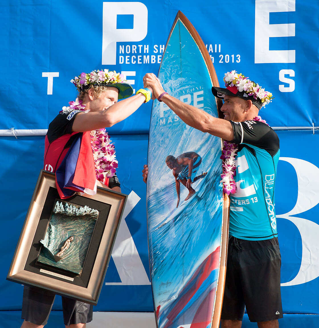2013 Pipe Masters winner, Kelly Slater with John John Florence and the Pipe Masters trophy surfboard