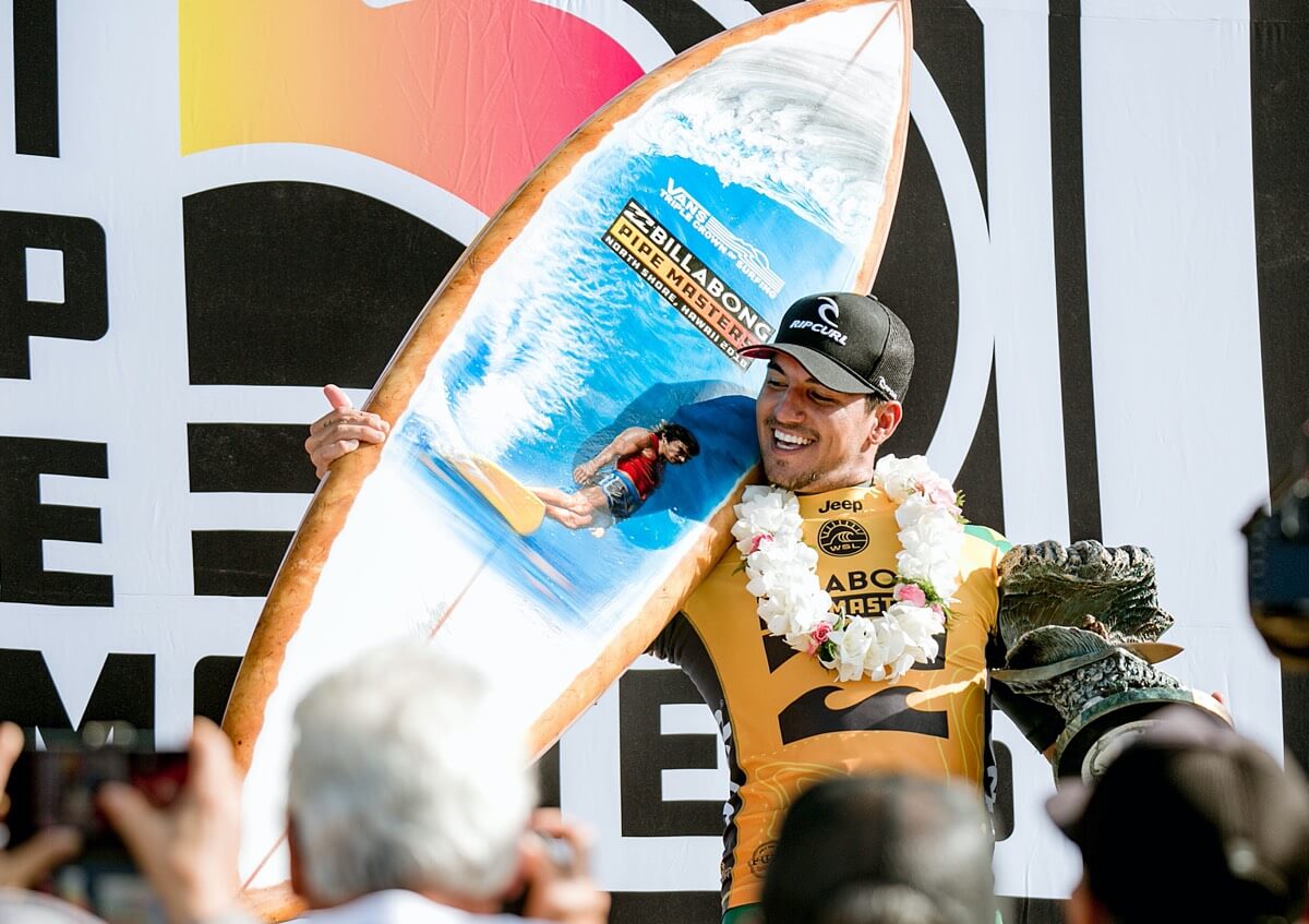 2018 Pipe Masters champion, Gabriel Medina with the 2018 Pipe Masters trophy surfboard by Phil Roberts