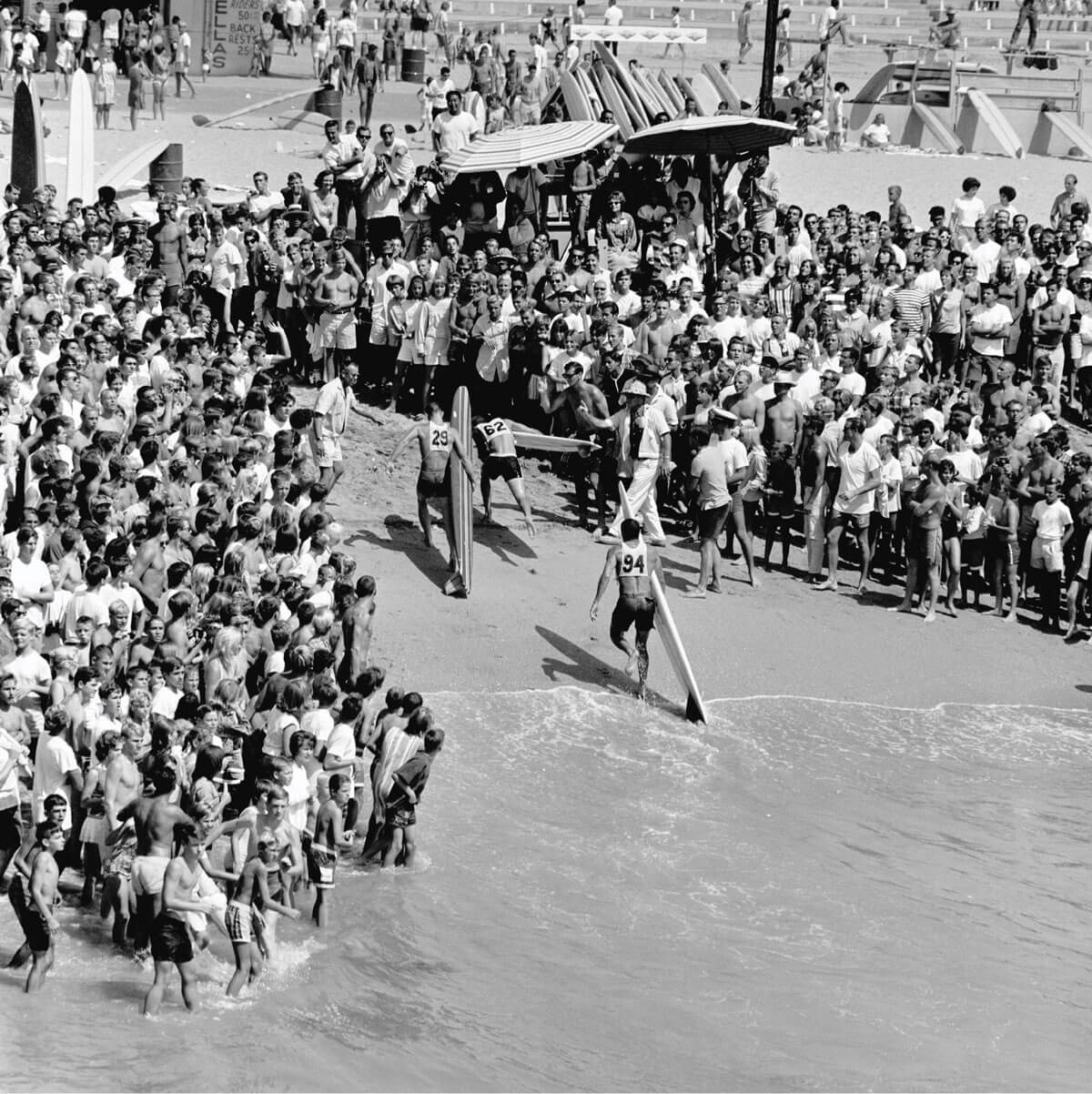 Surfers on crowded beach at a surf competition