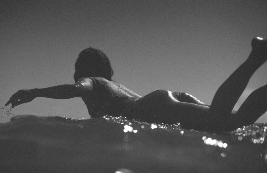 Female surfer paddling