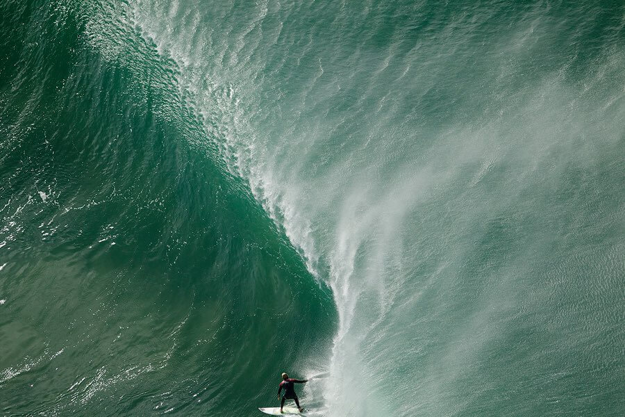 Aerial view of surfer riding wave