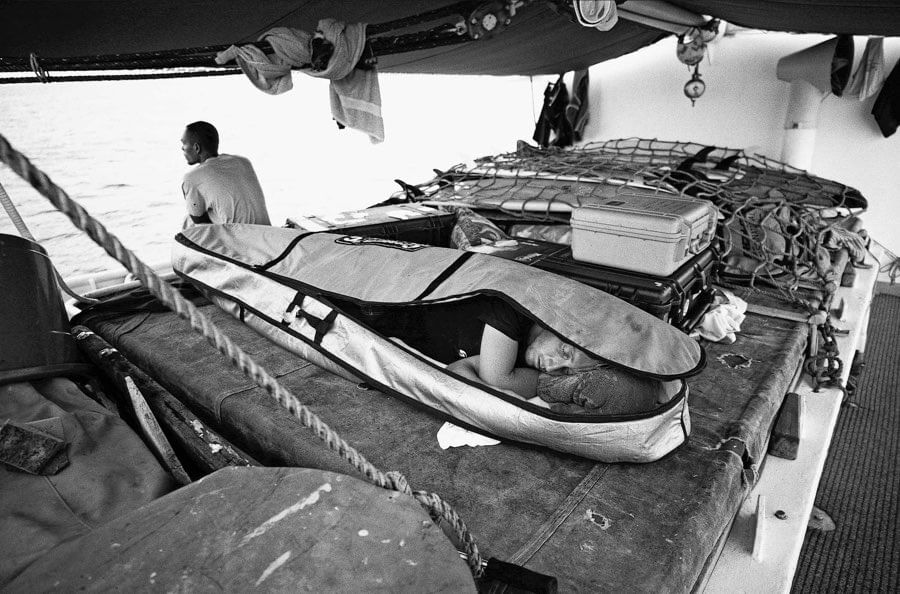 Surfer sleeping in board bag